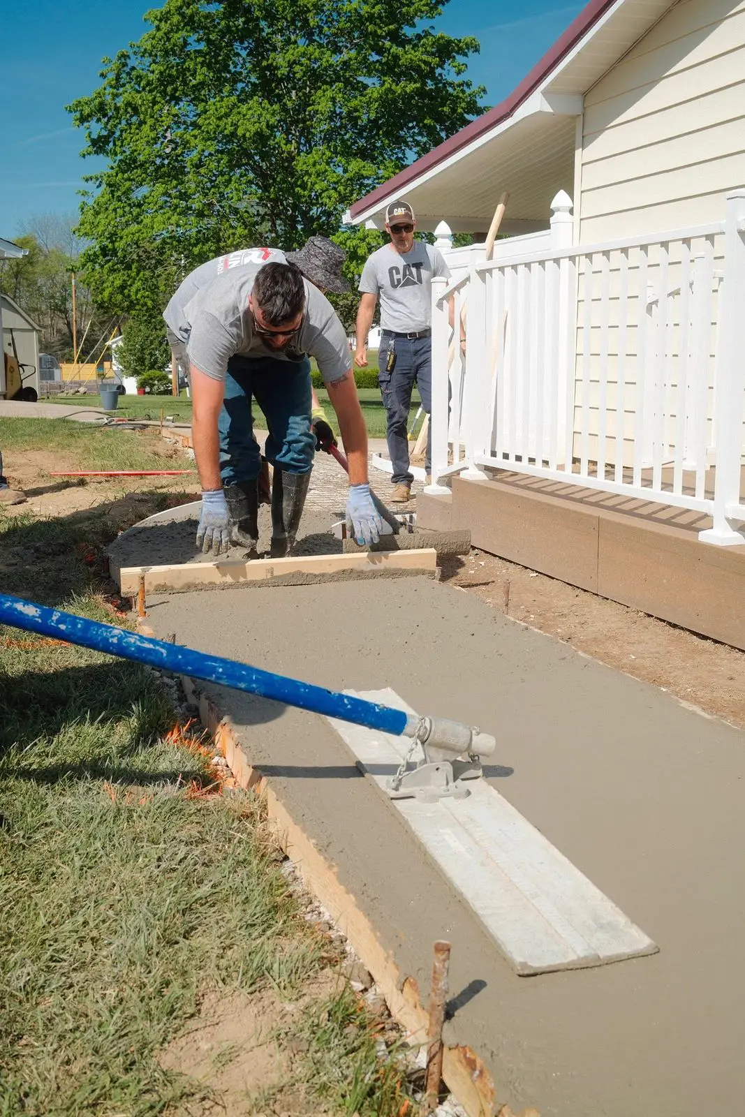TH Concrete crew screeding a fresh pour by hand