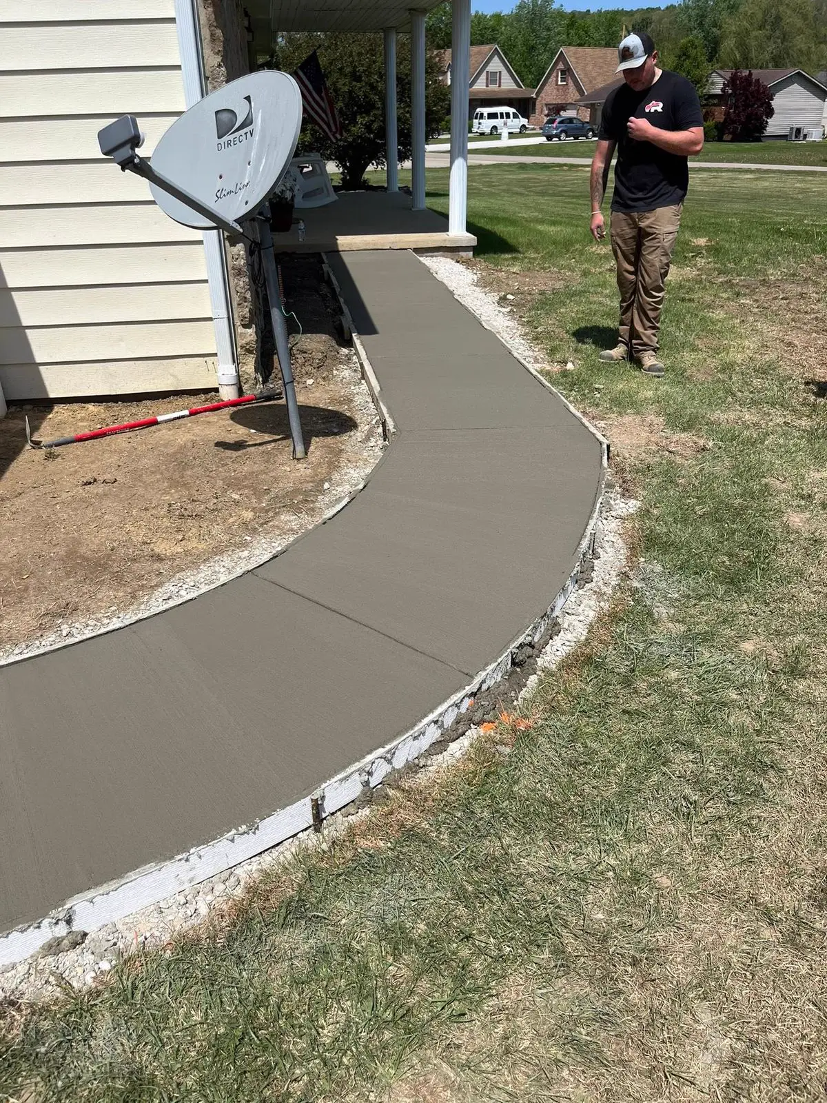 Curving fresh concrete sidewalk finished by TH Concrete