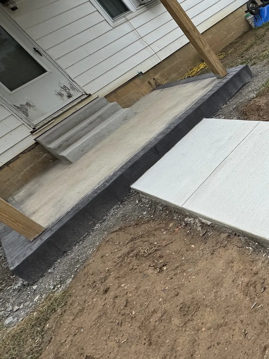New concrete steps beside a charcoal stamped brick border by TH Concrete in Portsmouth, Ohio