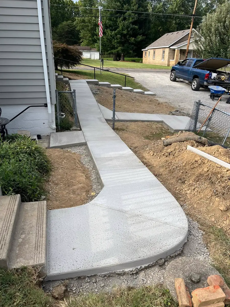Long sidewalk and steps beside a home