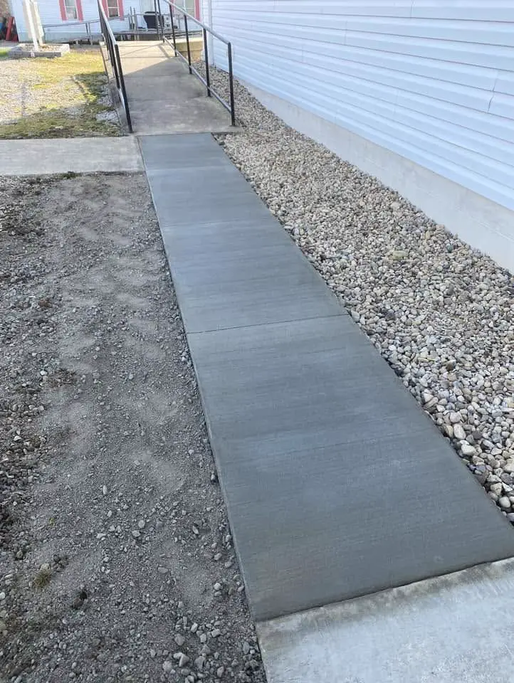 Concrete walkway ribbon with gravel border