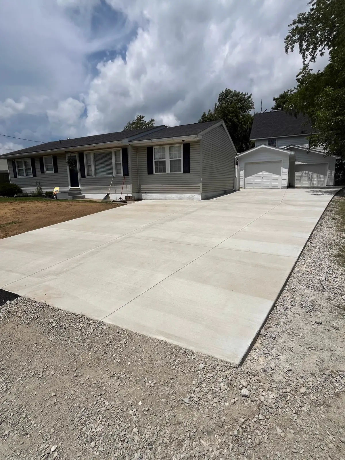 Fresh concrete driveway poured by TH Concrete in front of a Portsmouth, Ohio home