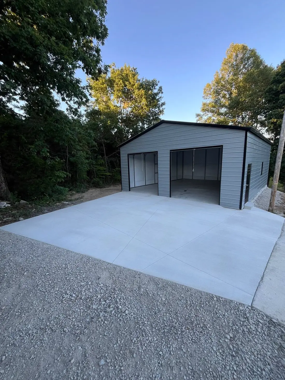 Finished slab for a metal garage with gravel drive