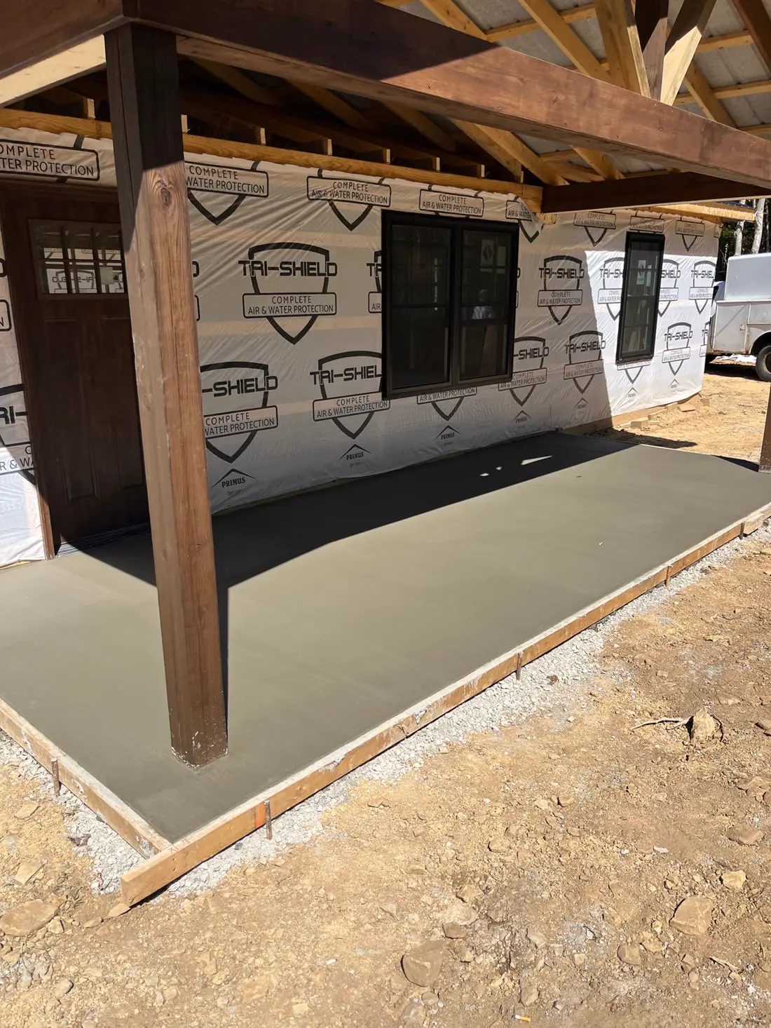 Covered porch slab poured and finished by hand